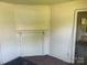 A room with a blocked fireplace, walls covered with wood planks, and a glimpse into the kitchen at 213 Maple St, Rock Hill, SC 29730