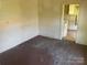 An interior shot of a room with wood flooring, wooden walls, and view to the kitchen at 213 Maple St, Rock Hill, SC 29730