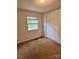 Bedroom featuring a window with a view of trees and a closet at 2216 Helen Dr, Gastonia, NC 28054