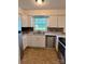 Kitchen featuring stainless steel appliances, white cabinets, and a double sink at 2216 Helen Dr, Gastonia, NC 28054