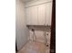 Functional laundry area with overhead cabinets, tiled floors and necessary appliance connections at 2216 Helen Dr, Gastonia, NC 28054