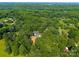 Aerial view of a wooded property featuring a home, large driveway and a detached garage at 229 Campsite Rd, Rock Hill, SC 29732