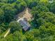Aerial view of a spacious brick home, large driveway, mature trees, detached garage and covered parking at 229 Campsite Rd, Rock Hill, SC 29732