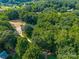 An aerial view of a home surrounded by lush greenery in a private, wooded lot at 229 Campsite Rd, Rock Hill, SC 29732