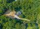 Aerial view of a private residence with a large driveway, in a wooded area, featuring an in-ground pool at 229 Campsite Rd, Rock Hill, SC 29732