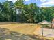 View of the spacious backyard, a covered structure, mature trees and a basketball hoop at 229 Campsite Rd, Rock Hill, SC 29732