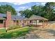 Brick home featuring a wooden beam carport and garden with vibrant flowers and plants at 229 Campsite Rd, Rock Hill, SC 29732