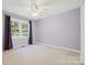 Bedroom offers carpet floor, ceiling fan, and large window with purple drapes at 229 Campsite Rd, Rock Hill, SC 29732