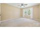 Bright, carpeted bedroom featuring a ceiling fan and a window with white curtains at 229 Campsite Rd, Rock Hill, SC 29732