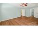 Spacious bedroom boasts hardwood floors, ceiling fan and multiple doors at 229 Campsite Rd, Rock Hill, SC 29732