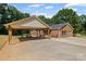 Brick home with large carport and concrete driveway surrounded by lush trees at 229 Campsite Rd, Rock Hill, SC 29732