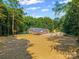 Exterior angle of a brick home with mature trees, large yard, detached garage and covered parking at 229 Campsite Rd, Rock Hill, SC 29732