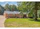 Charming brick home featuring lush green lawn and mature trees, perfect for outdoor enjoyment at 229 Campsite Rd, Rock Hill, SC 29732
