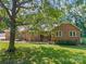 All brick home featuring lush green lawn and mature trees, offers charm and curb appeal at 229 Campsite Rd, Rock Hill, SC 29732