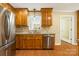 View of the kitchen sink and stainless steel dishwasher, and the wooden cabinets at 229 Campsite Rd, Rock Hill, SC 29732
