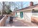 Private backyard deck with grill, sunny patio furniture and mature trees at 251 Gleneagles E Rd, Statesville, NC 28625