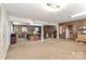 Open basement area with exposed ceilings and classic paneled walls at 251 Gleneagles E Rd, Statesville, NC 28625