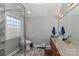 Elegant bathroom with a double sink, marble countertop, and a glass block window at 251 Gleneagles E Rd, Statesville, NC 28625
