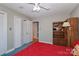 Cozy bedroom with a red quilt, ceiling fan, and built-in shelves at 251 Gleneagles E Rd, Statesville, NC 28625