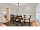 Formal dining room featuring a modern chandelier and a large window, perfect for entertaining at 251 Gleneagles E Rd, Statesville, NC 28625