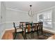 Well-lit dining room featuring crown molding, large windows, and a modern chandelier at 251 Gleneagles E Rd, Statesville, NC 28625
