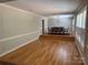 Bright dining room with hardwood floors, stylish lighting, and large windows with shutter style blinds at 251 Gleneagles E Rd, Statesville, NC 28625