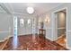 Elegant foyer showcasing intricate parquet floors, a decorative entry door, and stylish lighting fixtures at 251 Gleneagles E Rd, Statesville, NC 28625