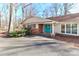 Inviting front entrance featuring a bright blue double door, brick accents and mature shrubbery at 251 Gleneagles E Rd, Statesville, NC 28625