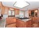 Kitchen featuring granite counters, stainless appliances, wood cabinets, and a view to the backyard at 251 Gleneagles E Rd, Statesville, NC 28625