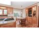 Kitchen dining area with wood floors, wooden cabinets and view of backyard at 251 Gleneagles E Rd, Statesville, NC 28625
