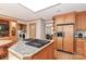 Bright kitchen with stainless steel appliances, wooden cabinets, and a granite island at 251 Gleneagles E Rd, Statesville, NC 28625