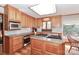 Well-equipped kitchen with granite countertops, stainless steel appliances, and natural wood cabinets at 251 Gleneagles E Rd, Statesville, NC 28625