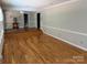 Open concept living space with raised floor area, crown molding, and hardwood flooring at 251 Gleneagles E Rd, Statesville, NC 28625