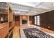Bright living room with brick fireplace, wood floors, and wood-paneled walls at 251 Gleneagles E Rd, Statesville, NC 28625