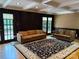 Inviting living room with dark wood paneling, neutral furniture, and access to the outdoors at 251 Gleneagles E Rd, Statesville, NC 28625