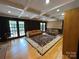 Cozy living room featuring wood paneled walls, hardwood floors and natural light from the french doors at 251 Gleneagles E Rd, Statesville, NC 28625