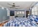 Bright main bedroom with a blue quilt, fan, and built-in television at 251 Gleneagles E Rd, Statesville, NC 28625