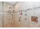 Elegant walk-in shower featuring tan tiling with mosaic accents and modern fixtures at 251 Gleneagles E Rd, Statesville, NC 28625
