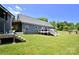 Large backyard with a deck, lawn, and fence, providing ample space for outdoor activities at 265 St Matthews Church Rd, Salisbury, NC 28146