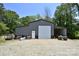 A large barn with roll-up door and covered area for parking machinery at 265 St Matthews Church Rd, Salisbury, NC 28146