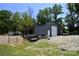 A well-maintained barn featuring a roll-up door with adjacent sheds at 265 St Matthews Church Rd, Salisbury, NC 28146