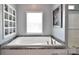 Soaking tub with a window and shelving at 265 St Matthews Church Rd, Salisbury, NC 28146