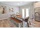 Bright dining room featuring a wooden dining table with a bench, and access to the backyard at 265 St Matthews Church Rd, Salisbury, NC 28146