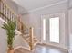 Bright foyer featuring hardwood floors, a staircase with an iron railing, and a glass front door at 265 St Matthews Church Rd, Salisbury, NC 28146