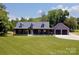 Charming home with a sprawling lawn and a welcoming covered front porch and detached 2-car garage at 265 St Matthews Church Rd, Salisbury, NC 28146