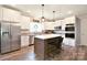 Bright kitchen with stainless steel appliances, white cabinetry, and center island with bar seating at 265 St Matthews Church Rd, Salisbury, NC 28146