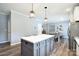 Open kitchen with a large center island, wood flooring, adjacent dining area, and stainless steel refrigerator at 265 St Matthews Church Rd, Salisbury, NC 28146