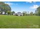Expansive, grassy backyard featuring a well-maintained lawn and partial view of the home at 329 W Red Cross Rd, Oakboro, NC 28129