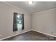 Small bedroom with plush carpeting featuring a window for natural light at 329 W Red Cross Rd, Oakboro, NC 28129