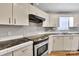 Well-lit kitchen featuring stainless steel appliances and plenty of cabinet storage space at 329 W Red Cross Rd, Oakboro, NC 28129